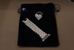 A decorative watch strap and ring.