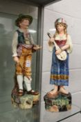 A pair of continental maiolica glazed pottery figures of musicians.