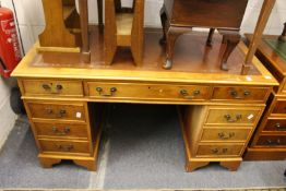 A reproduction yew wood pedestal desk.
