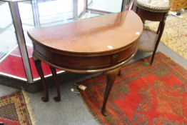 A George II / III mahogany demi-lune foldover tea table.