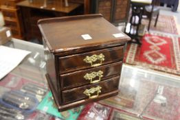A mahogany three drawer jewellery cabinet.