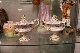 A pair of gilt and floral decorated sauce tureens and covers.