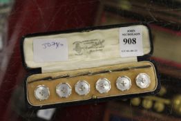 A cased set of silver and mother-of-pearl studs.