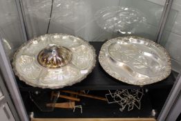 A silver plate and cut glass centrepiece and plated carving dish.