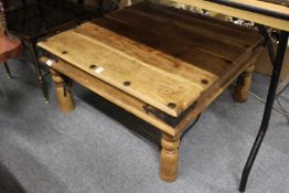 An eastern hardwood and metal bound coffee table.