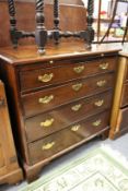 A George III mahogany four drawer chest with brushing slide.