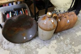 A metal tractor seat, together with a large flagon and a leather case.