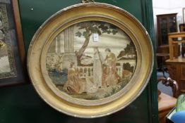 An oval silk work picture.