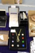 Three boxed items of jewellery.