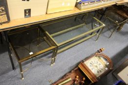 A brass and glass two tier coffee table and a pair of matching lamp tables.