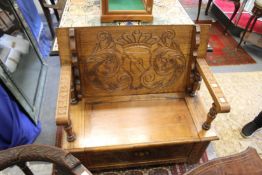 A carved oak monk's bench.