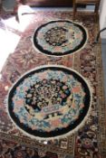 A pair of Chinese circular small rugs.
