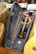An electronic violin, cased.