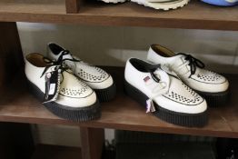 Two pairs of Underground shoes.