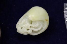 A Chinese carved jade pebble.