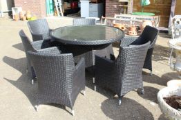 A good patio set comprising a large circular table and six armchairs, all with modern woven material