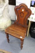 A Victorian mahogany hall chair.