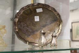 A plated salver and two pepperettes.