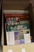 A box of stamp reference books.