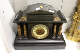A Victorian black slate mantle clock.