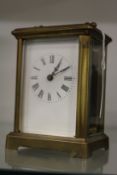 A brass carriage clock.