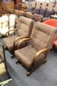 A pair of beech framed rocking armchairs.