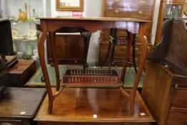 An Edwardian walnut two tier occasional table.