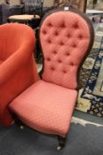A Victorian walnut framed and button upholstered bedroom chair.