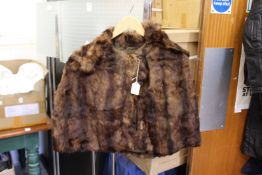A ladies' small fur jacket.