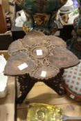 A carved wood stool or occasional table.