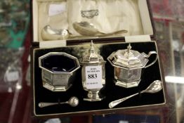 A cased silver three piece condiment set and various small items of flatware.
