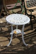 A small white painted aluminium patio table.