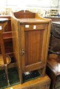 An Edwardian walnut pot cupboard.