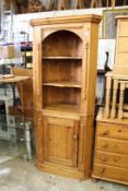 A pine corner cabinet.