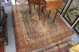 An old Persian rug, worn.