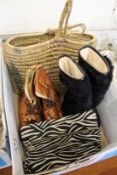 An evening bag, two pairs of boots and a wicker shopping basket.