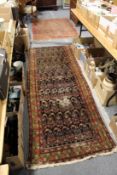 An old Persian runner and a small Persian rug (AF).