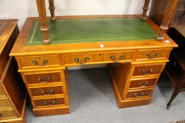A reproduction yew wood pedestal desk.