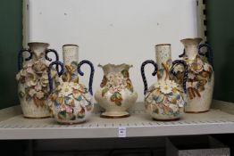 Decorative floral encrusted vases.