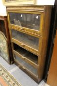 An oak Globe Wernicke style four section stacking bookcase (one section lacking glass).
