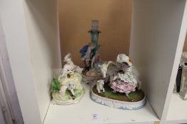 Three decorative porcelain figure groups.