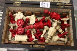 A part chess set in a walnut box.