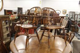 A set of eight Windsor style splat back ash and elm dining chairs, two with arms.