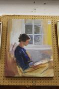 A lady seated reading a book, oil on canvas, unframed.