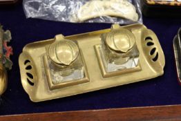 A small Art Nouveau brass and glass double inkwell.