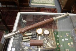 A leather cased pocket barometer and a telescope.
