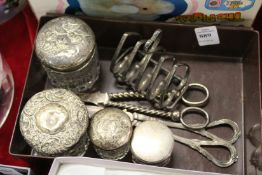 A small toast rack, silver topped dressing table jars, grape scissors.