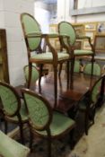 A set of eight mahogany framed shield back dining chairs, two with arms.