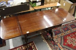 A reproduction mahogany sofa table.