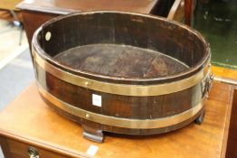 A brass bound teak wine cooler by R. A. Lister & Co Ltd.